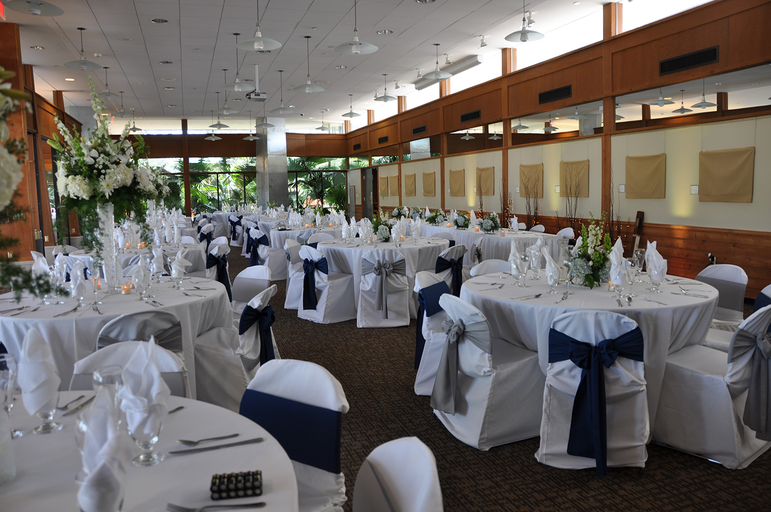 Tables and chairs set up for a wedding reception in the Garden Room.