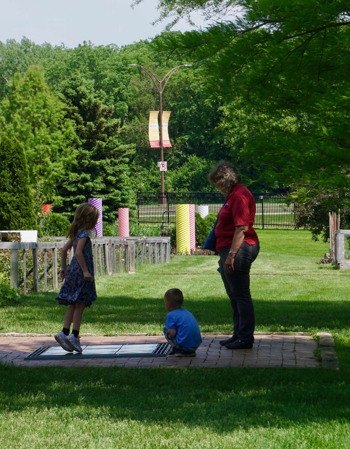 Children jump on the dancing chimes, with a parent watching.