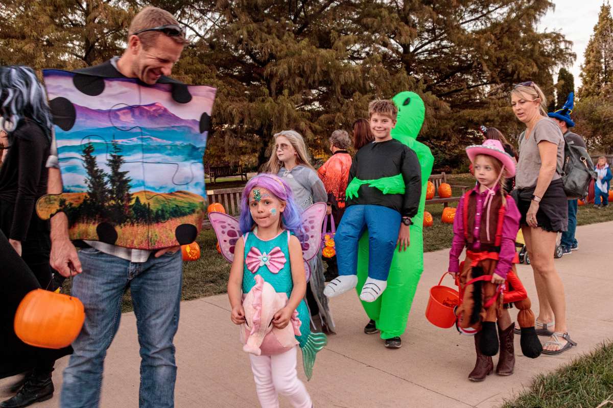 Families in costume enjoy a Halloween celebration